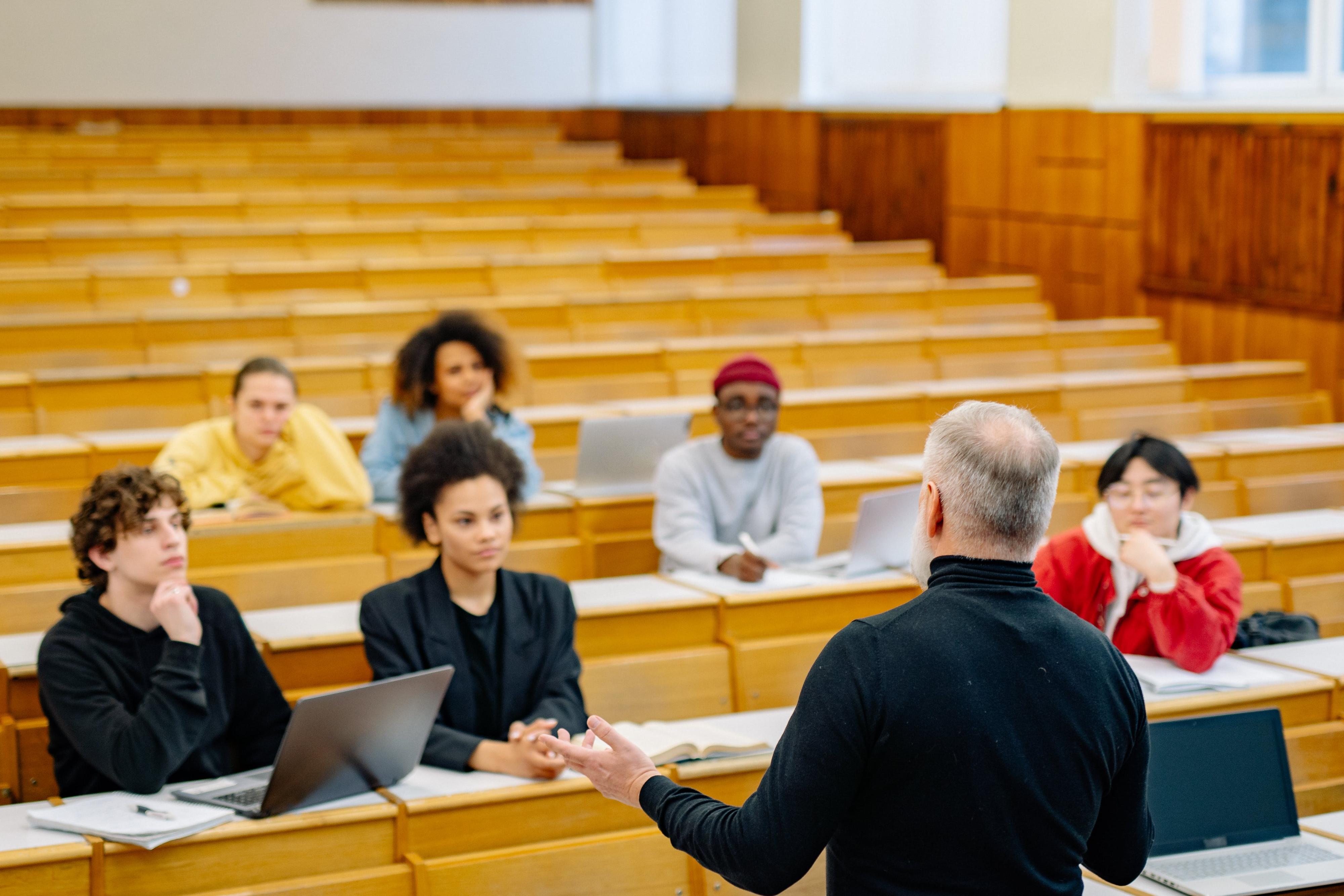 An image of a faculty member teaching a small glass.