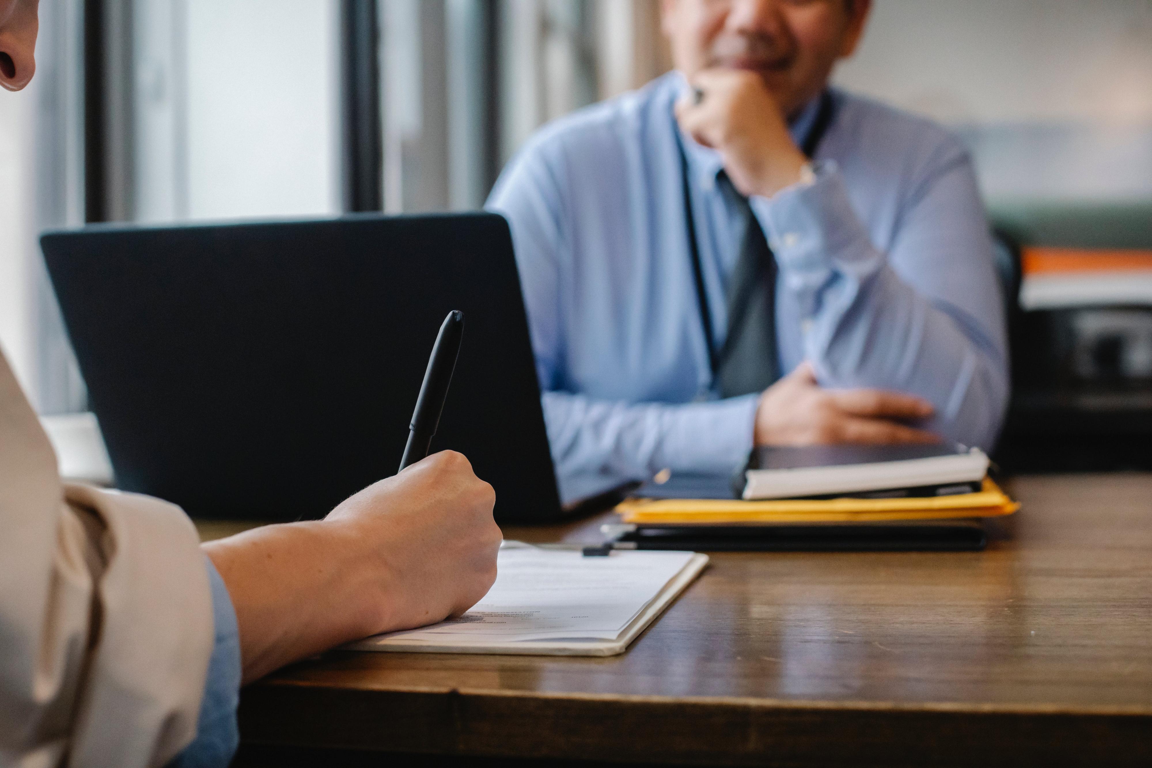 A person being interviewed by another person for a job.