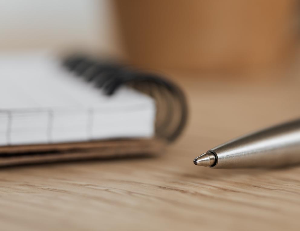 A pen and pad of paper.