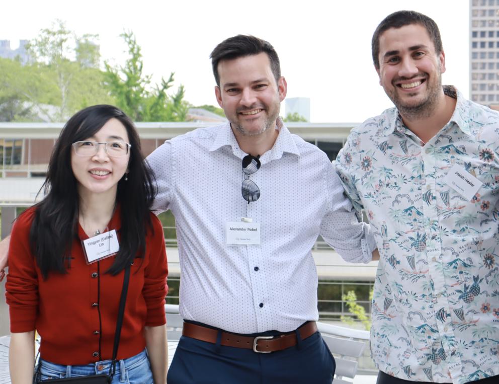 A group of faculty standing together at the tenure celebration.